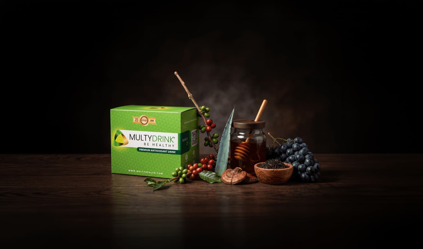 Caja de MultyDrink junto a sus ingredientes naturales: miel, café, ganoderma, té negro y uva, hecha en Colombia